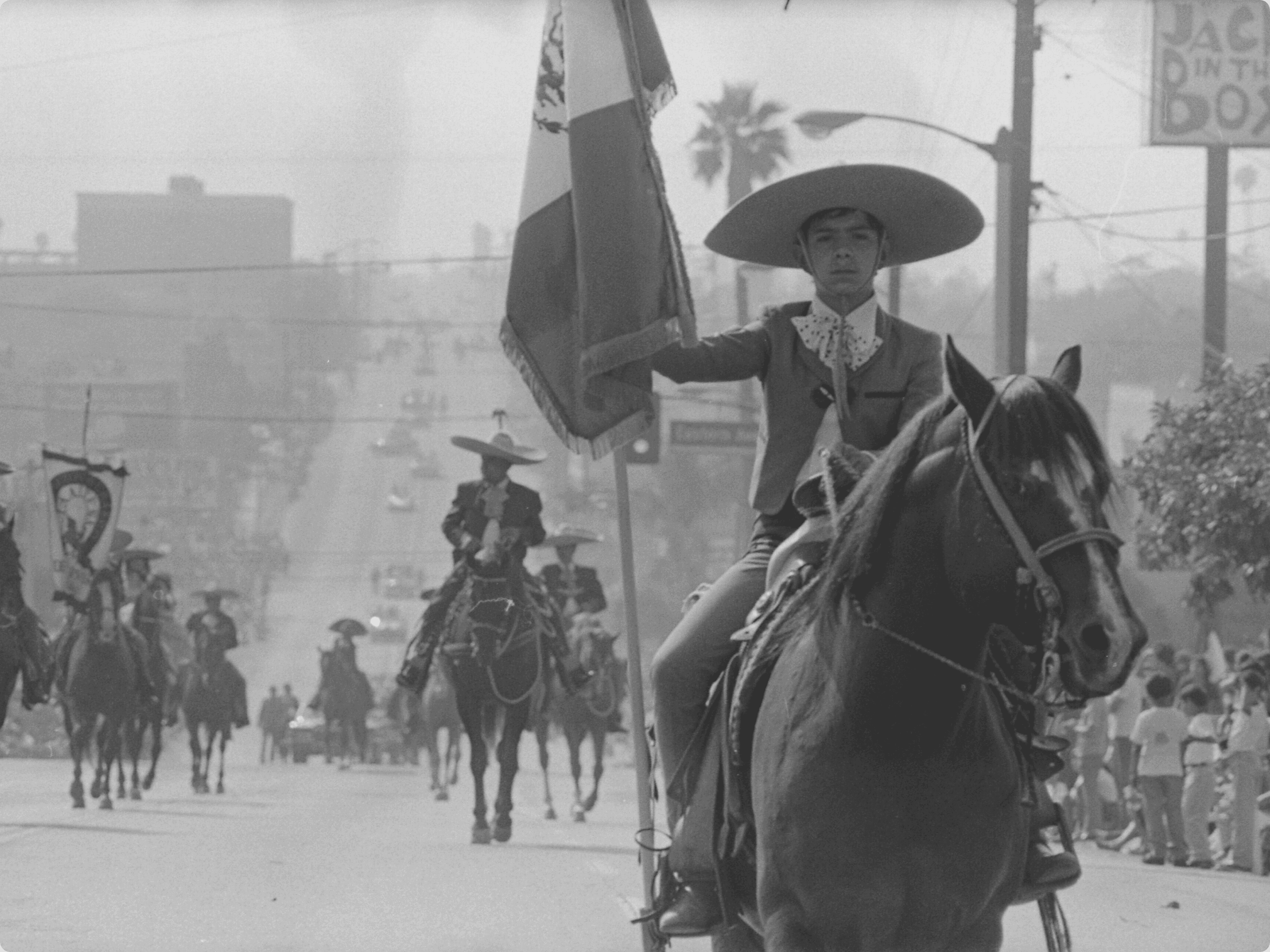 Charros riding horses in a Mexican Independence Day parade in East Los Angeles, California, 1973.